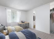 Thumbnail 12 of 25 - Two Bedroom Apartments in Santa Cruz CA - Cypress Point - Spacious Bedroom Furnished with Two Beds, Carpeted Floor, Nightstand, Desk, and Large Closets