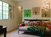 Thumbnail 16 of 51 - a bedroom with a bed and paintings on the wall