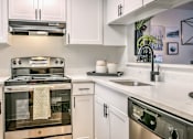 Thumbnail 1 of 27 - A modern kitchen with a stove, oven, and a dishwasher.