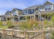 Thumbnail 12 of 51 - a row of houses with a wooden fence