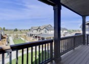 Thumbnail 25 of 51 - the view from the deck of a home with a yard and houses