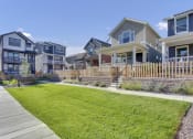 Thumbnail 1 of 51 - a row of houses with a yard and a sidewalk