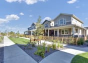 Thumbnail 30 of 51 - a house with a yard and a sidewalk in front of it