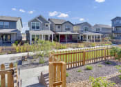 Thumbnail 17 of 51 - a row of houses with a yard and a wooden fence