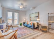 Thumbnail 5 of 34 - a living room with a blue couch and white chairs