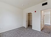 Thumbnail 30 of 36 - A room with a carpeted floor and a white wall.