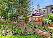 Thumbnail 52 of 52 - A sign for Whitewater Park Apartments stands in front of a flower bed.