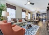 Thumbnail 4 of 30 - Model Unit Living Room to Kitchen at Avino in San Diego, CA 92130