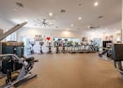 Thumbnail 25 of 48 - A gym with a variety of exercise equipment and a sign that says