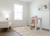 Thumbnail 10 of 15 - A white chair sits in front of a desk with a pink chair in front of it.