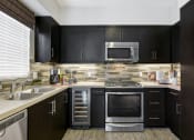 Thumbnail 2 of 30 - Model Unit Kitchen at Avino in 92130