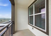 Thumbnail 29 of 55 - A balcony with a window and a railing.