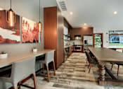 Thumbnail 29 of 48 - Communal dining space with wood cabinetry and pendant lights at Canyon Creek Apartments, Oregon, 97070