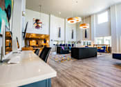 Thumbnail 25 of 44 - A modern living room with a white counter and a large painting on the wall.