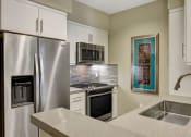 Thumbnail 25 of 30 - Model Unit Kitchen at Avino in San Diego, CA