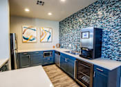 Thumbnail 26 of 44 - A kitchen with a white counter top and blue cabinets.
