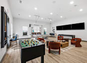 Thumbnail 13 of 55 - A room with a foosball table and a couch.