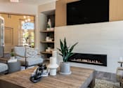 Thumbnail 9 of 38 - a living room with a coffee table and a fireplace