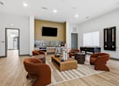 Thumbnail 49 of 55 - A modern living room with a wooden floor and a television mounted on the wall.