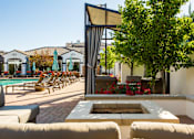 Thumbnail 14 of 38 - Outdoor Lounge With Firepit at SkyStone Apartments, Albuquerque