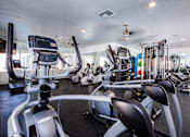 Thumbnail 29 of 44 - A gym with treadmills and other exercise equipment.