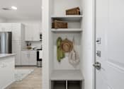 Thumbnail 48 of 55 - A kitchen with white cabinets and a white door.