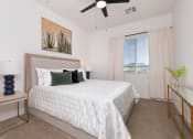 Thumbnail 24 of 59 - a bedroom with a large white bed and a ceiling fan at Element 12 Apartments, Henderson NV