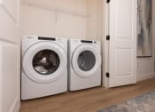 Thumbnail 28 of 59 - a washer and dryer in a laundry room next to a door at Element 12 Apartments, Henderson NV