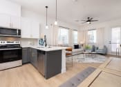 Thumbnail 15 of 59 - a living room with a kitchen and an open floor plan at Element 12 Apartments, Henderson NV