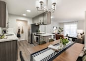 Thumbnail 3 of 48 - Open concept kitchen and dining with modern island at Canyon Creek Apartments, Wilsonville