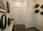 Thumbnail 26 of 38 - a hallway with white doors and a desk and a door to a closet