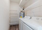 Thumbnail 23 of 36 - A small laundry room with a washer and dryer.