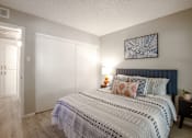 Thumbnail 7 of 18 - A bedroom with a large bed and a painting on the wall.
