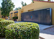 Thumbnail 17 of 18 - A yellow house with a black garage door.