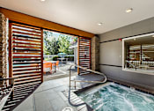 Thumbnail 35 of 48 - Indoor hot tub with patio access and privacy screens at Canyon Creek Apartments, Oregon, 97070