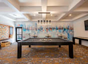 Thumbnail 30 of 48 - A room with a pool table and a TV.