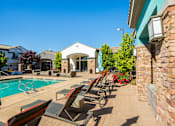 Thumbnail 8 of 38 - Poolside Sundeck With Relaxing Chairs at SkyStone Apartments, Albuquerque, 87114