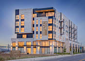 Thumbnail 35 of 36 - A modern building with the words "LEASING" and "NOW" on its facade.