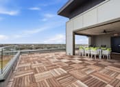 Thumbnail 27 of 55 - Roof-top lounge area with table, chairs, TV entertainment