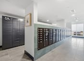 Thumbnail 28 of 55 - A hallway with a row of lockers on the right side.