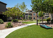 Thumbnail 35 of 48 - A grassy area in front of apartment buildings.