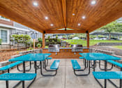 Thumbnail 38 of 48 - Covered bbq area with picnic tables and grills at Canyon Creek Apartments, Wilsonville, 97070