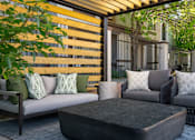 Thumbnail 15 of 38 - a patio with couches and a coffee table