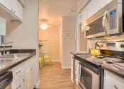 Thumbnail 7 of 9 - Gourmet Kitchen with Breakfast Bar and Pantry at Eagle Point Apartments, New Mexico, 87111