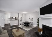 Thumbnail 10 of 22 - a living room with a table and chairs and a fireplace