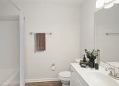 Thumbnail 15 of 22 - a bathroom with white walls and a white toilet next to a white sink