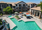 Thumbnail 38 of 48 - A swimming pool surrounded by apartment buildings.
