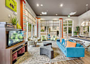 Thumbnail 11 of 28 - A living room with a television, couch, and pool table.