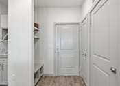 Thumbnail 31 of 55 - A white door is in the middle of a hallway.