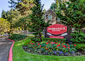 Thumbnail 21 of 33 - Monument sign with colorful landscaped flower beds at Hubbard's Crossing Apartments, Kirkland, WA 98034